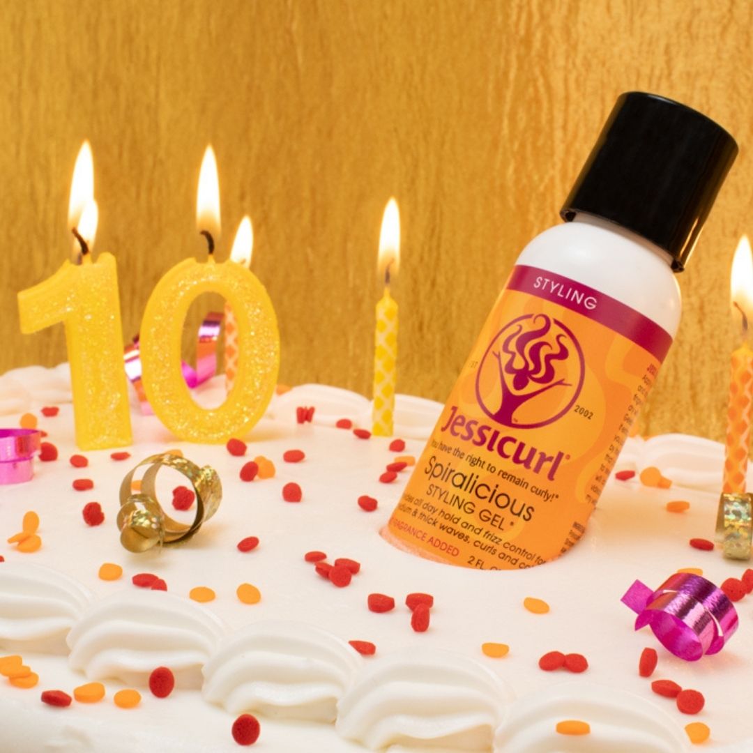 Spiralicious bottle on cake with lit candles and sprinkles