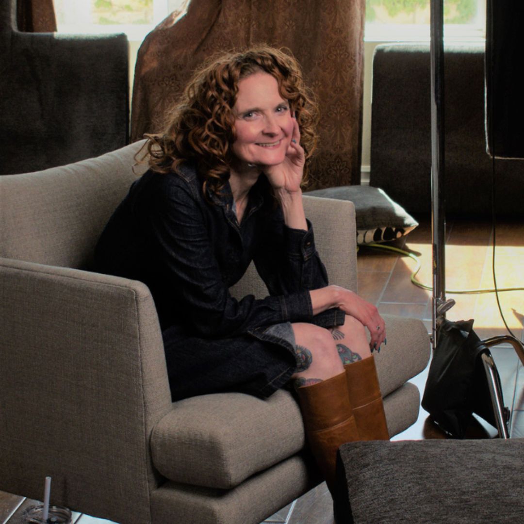 Photo of Jessica McGuinty sitting on chair behind video camera.