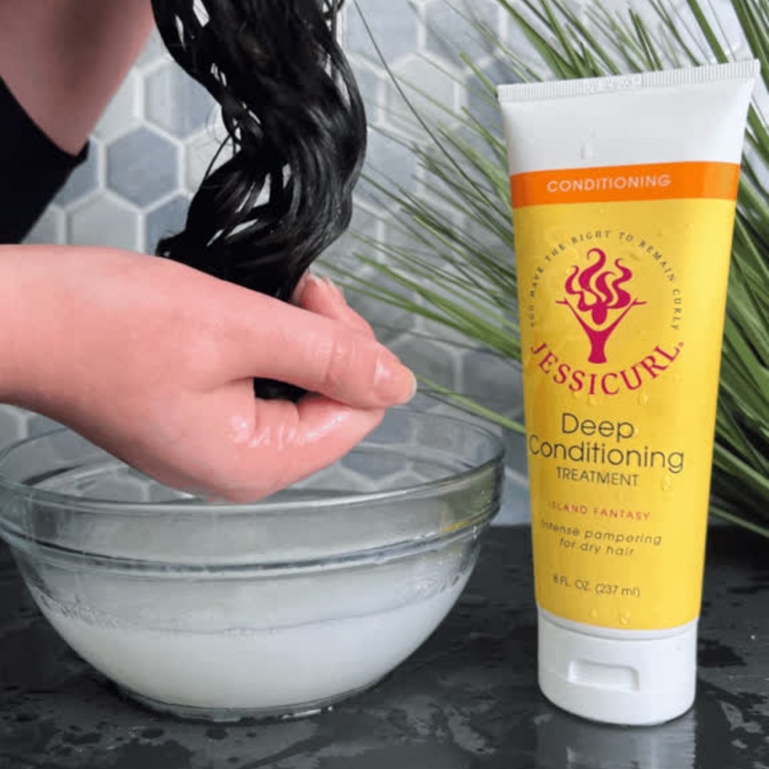 curly haired woman squishing the Deep Conditioner through her locks with the Bowl Method