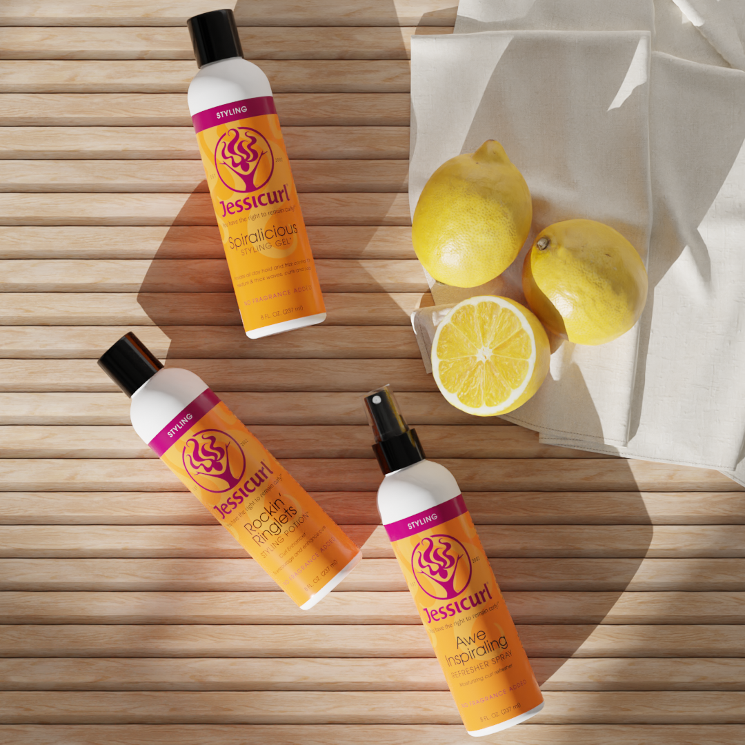 Jessicurl Stylers laying on a porch next to lemons and a white cloth