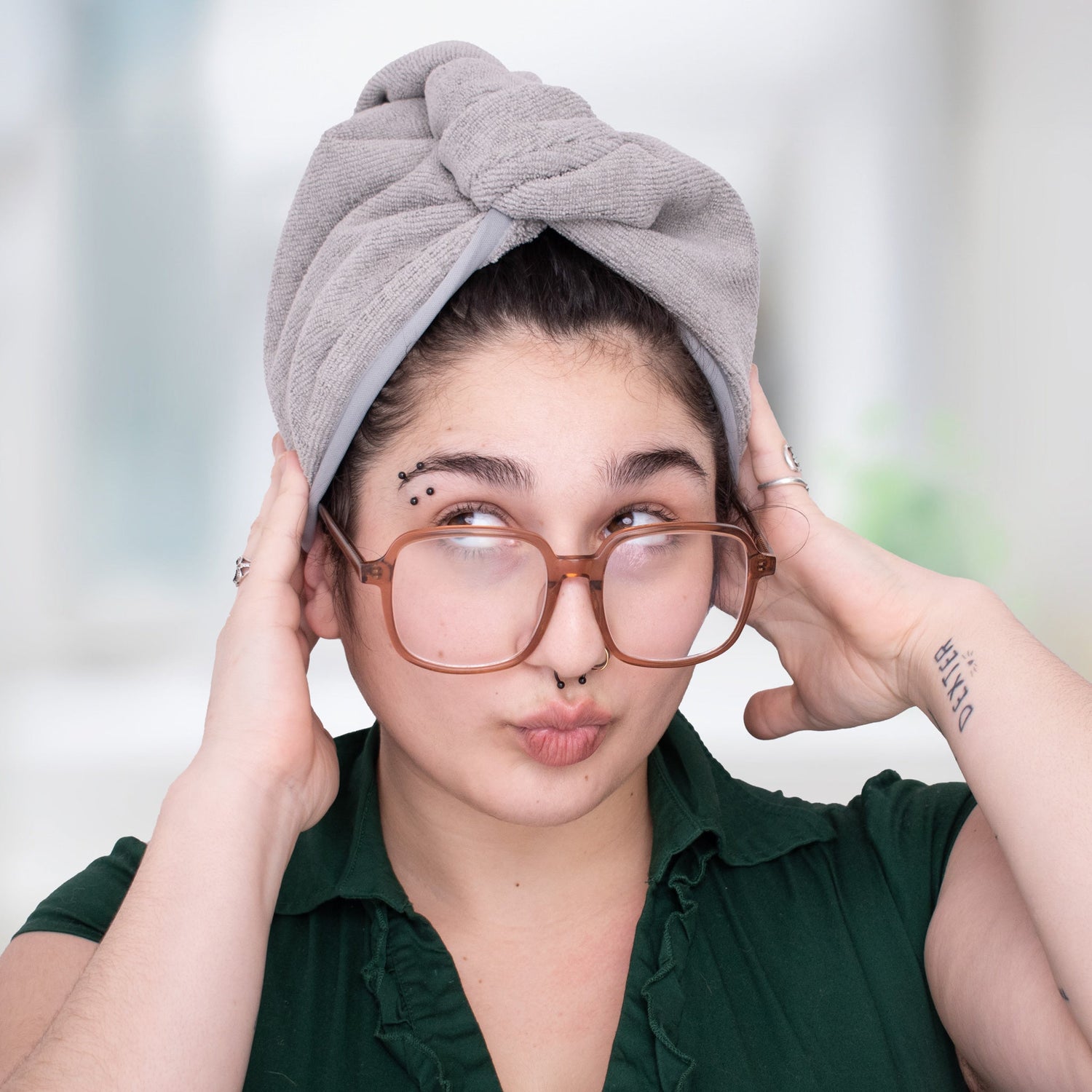 curly haired woman with her hair in a microfiber towel