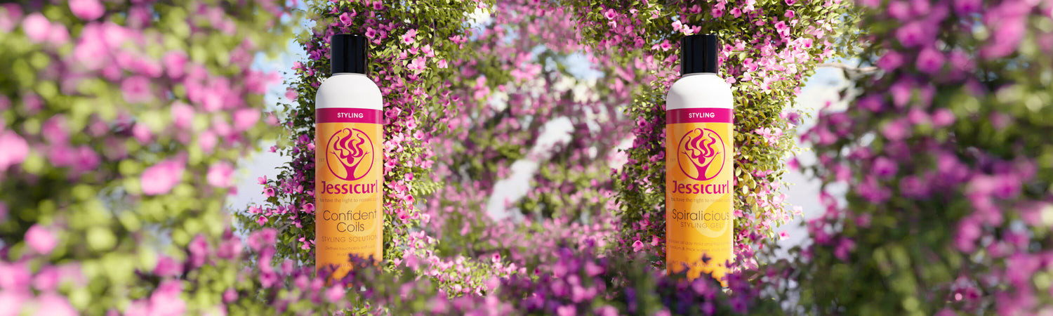 Jessicurl Confident Coils Styling Solution and Spiralicious Styling Gel in the middle of a purple flower tunnel.