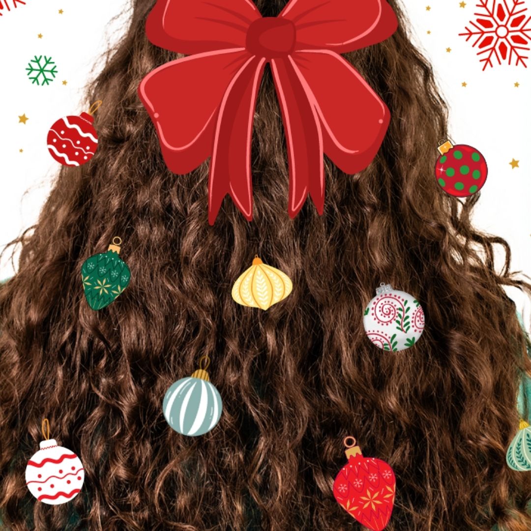 back of curly haired woman's head with multicolored ornaments in her hair with a red bow at the top