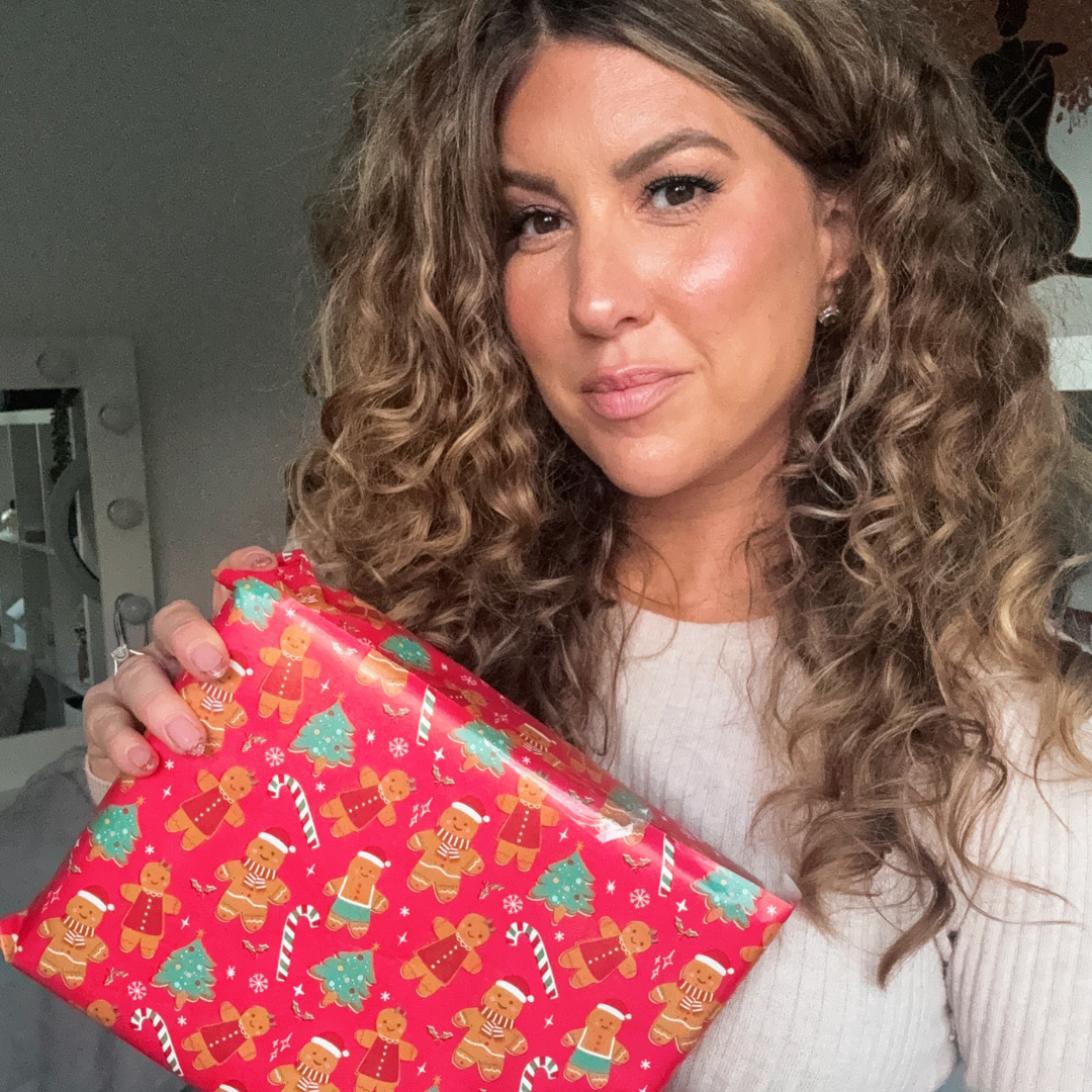 Chief Educator Claire holding a wrapped present