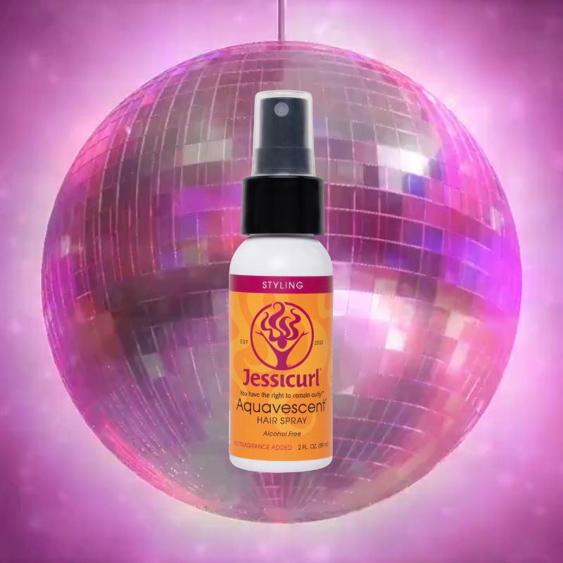 a 2 oz bottle of Aquavescent Hair Spray in front of a pink tinted disco ball