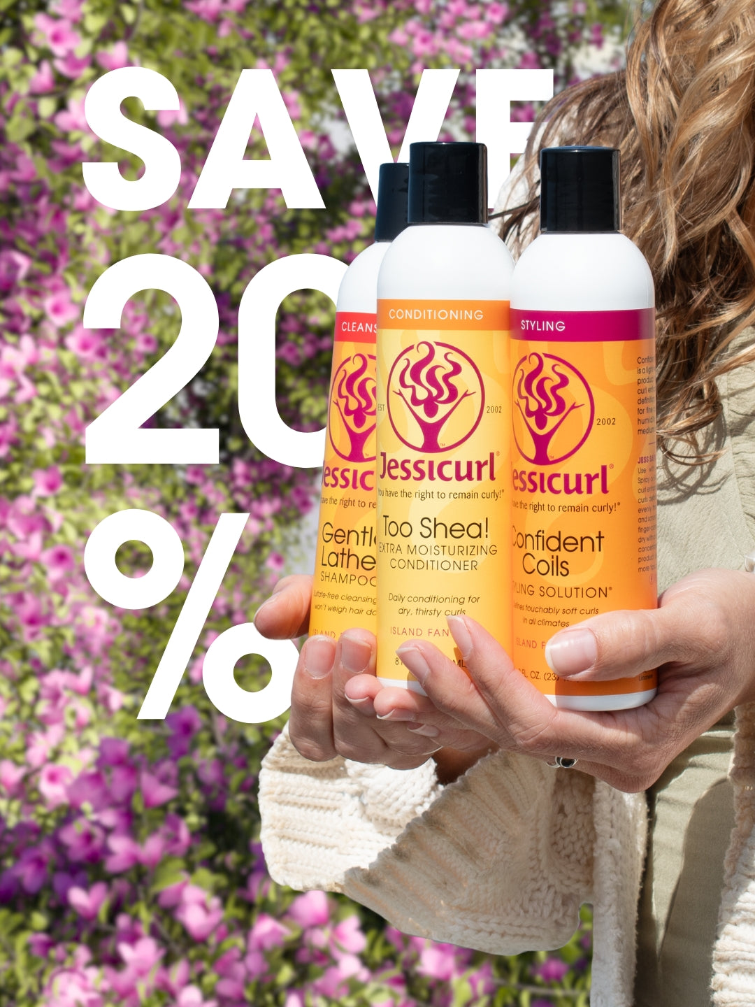 Jessicurl Confident Coils Styling Solution and Spiralicious Styling Gel in the middle of a purple flower tunnel.